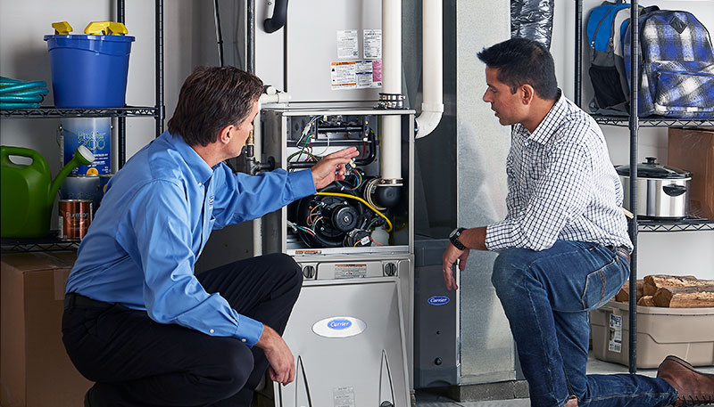 HVAC technician evaluating a furnace for repair or replacement in Aurora