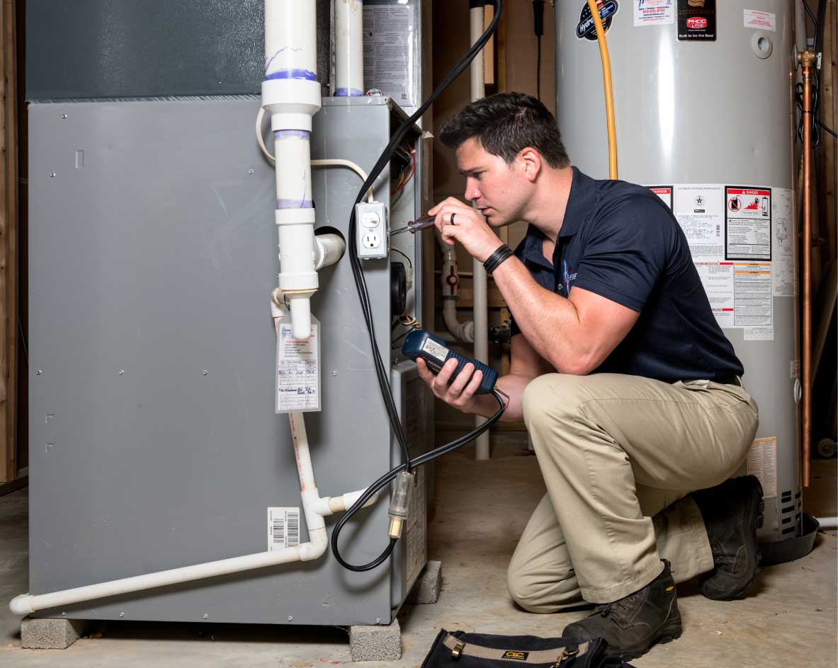 HVAC technician performing a furnace tune-up in Aurora