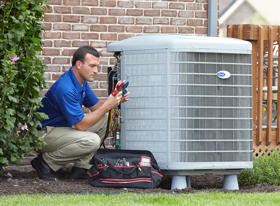 HVAC technician inspecting an outdoor air conditioning unit in Aurora