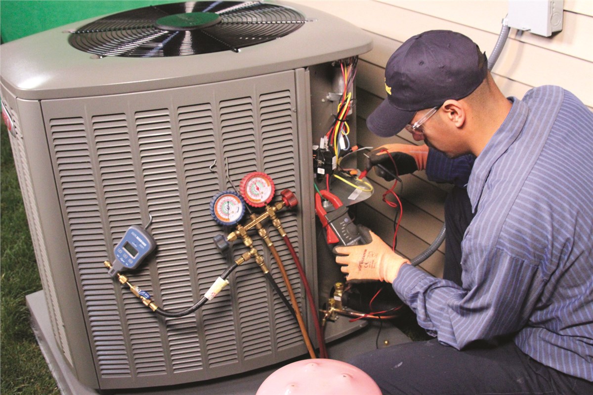 HVAC technician testing an outdoor air conditioning unit in Aurora